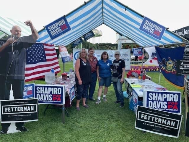 Group of Democratic volunteers in an outdoor booth for the Labor Day United Celebration at Northmoreland Park in 2022.